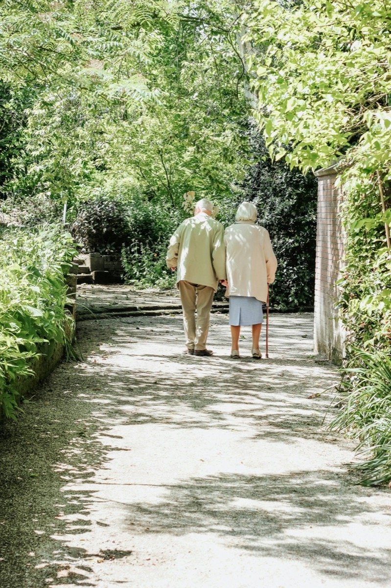 A happy senior couple walking together outdoors